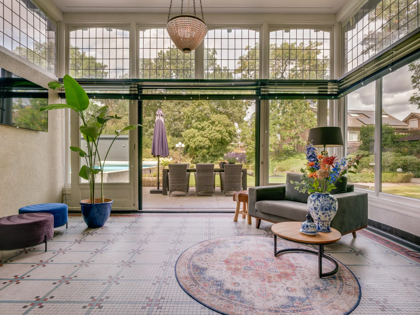A luxurious house room with elegant furniture, large windows, and tasteful decor, showcasing a blend of classic and modern design elements.